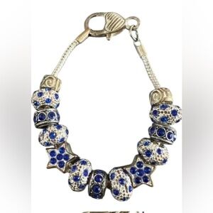 Silver tone clasp snake chain bracelet with silver and blue charms
